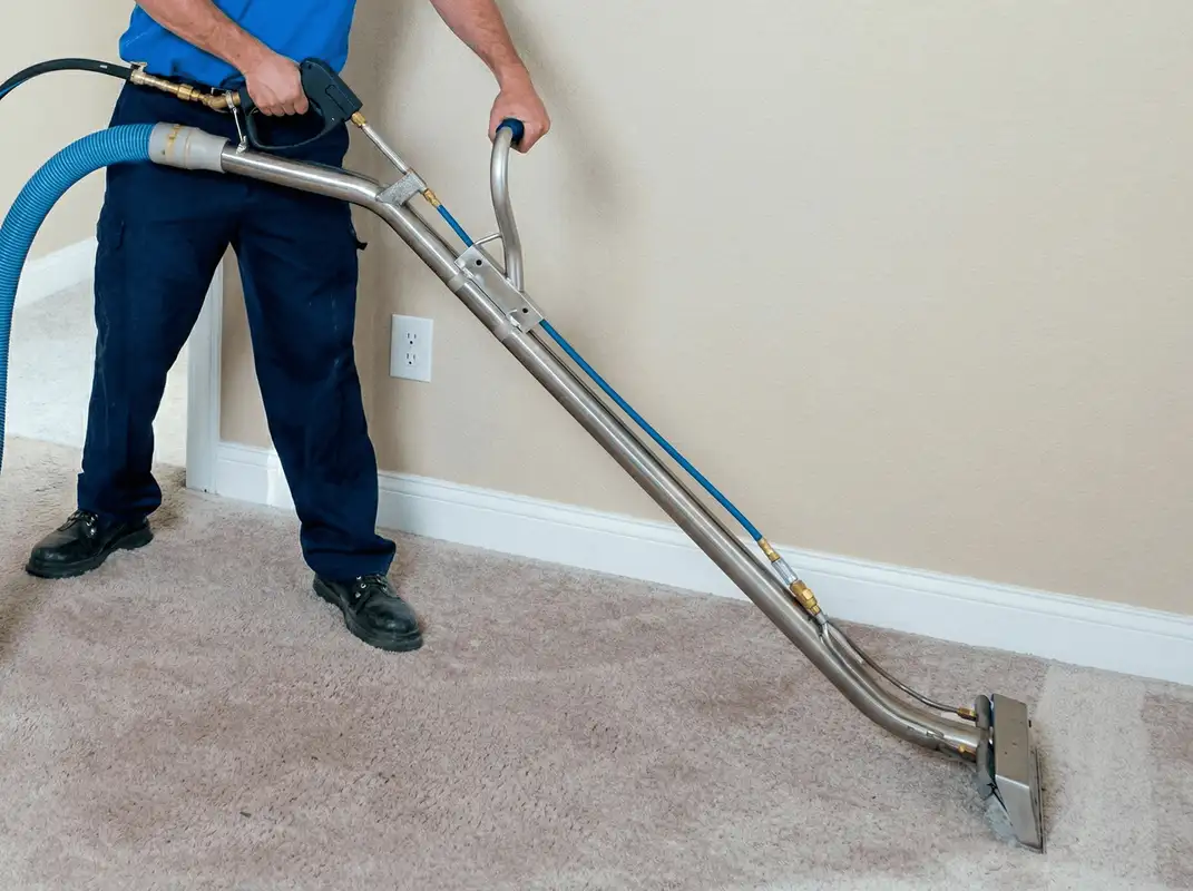 Professional operating a liquid removal machine on a carpeted floor in Orlando, FL