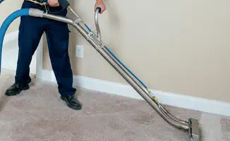 Professional operating a liquid removal machine on a carpeted floor in Orlando, FL